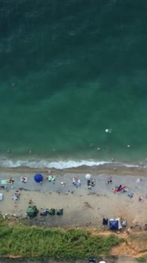 Aerial Timelapse View Over Sandy Beach During Summer Sunset Crowds of Happy People Relax By the Blue