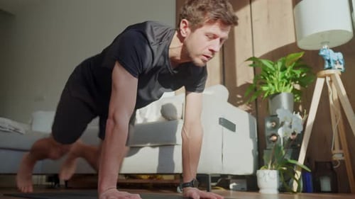 Man Doing Mountain Climber Exercise on Fitness Mat at Home