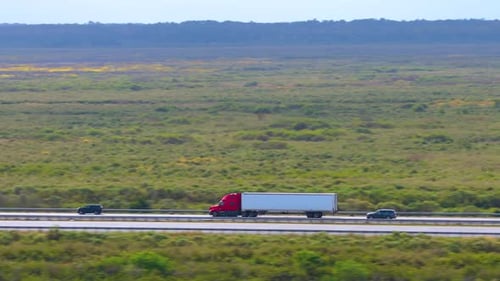 Semi Truck Driving on Interstate Freeway Hauling Cargo Delivering Loads Concept