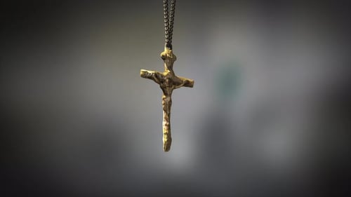 High quality close up render of a beautiful antique gold Christian Crucifix artifact swinging slowly