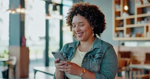 Black woman, phone and laughing for funny joke, meme or social media post online at indoor cafe