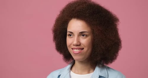 Smiling Attractive African American Woman Standing Over Pink Studio Background