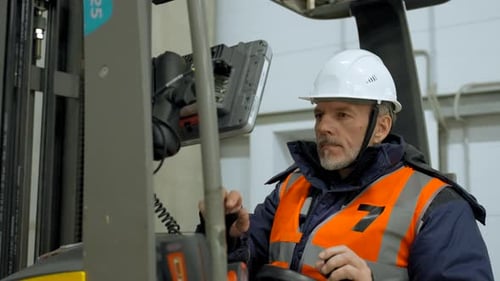 Man Operating Forklift in a Warehouse