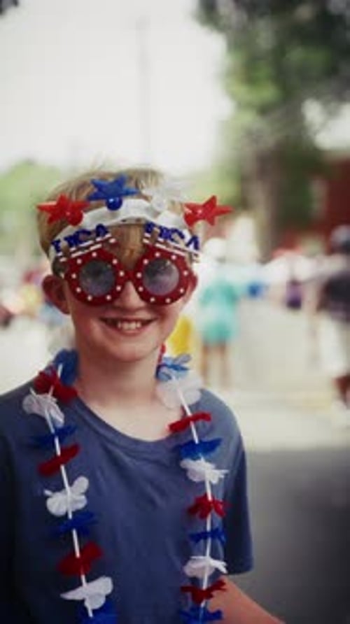 Young Boy Wearing USA Glasses And Star Headband Celebrating Independence Day