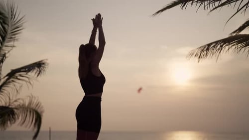 Woman Practices Yoga on Ocean at Sunset Silhouette Sporty Yoga Girl Doing Yoga Pose Asana Exercise