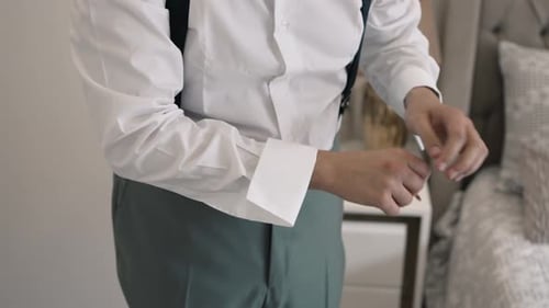 Man Attaching Cufflinks Before Wedding Ceremony