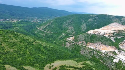 Natural Quarry is Located Near Road Against Backdrop of Rhodope Mountains and Hills with Forests and