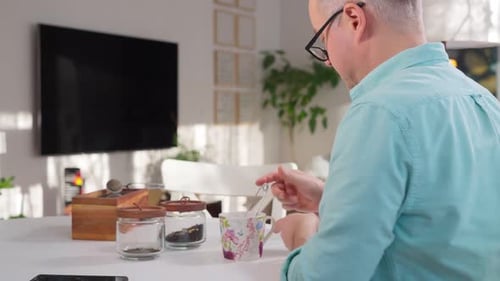 Adult Man Making Tea in a Home Setting