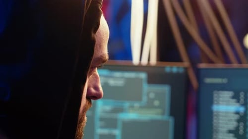 Extreme Close Up of Rogue Programmer Running Code in Graffiti Painted Basement