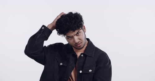 Confused, thinking or face of man scratching head in studio with question