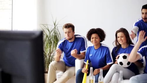 Multiethnic friends watch a disappointing soccer game on tv at home together