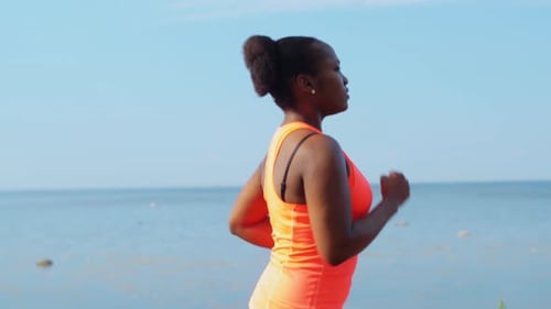 Fitness, Sport and Healthy Lifestyle Concept - Young African American Woman Running