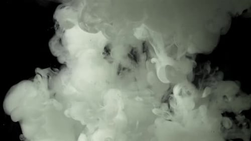 Swirling plumes of white smoke against black backdrop
