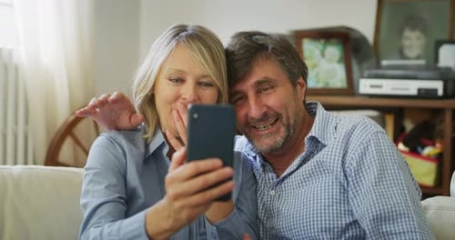 Cheerful Couple Video Calling From Home Living Room