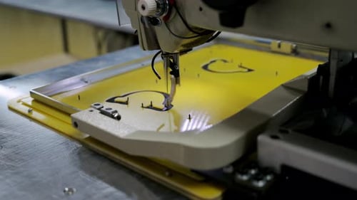 Automatic Sewing Machine Operates with Fabric in Workshop