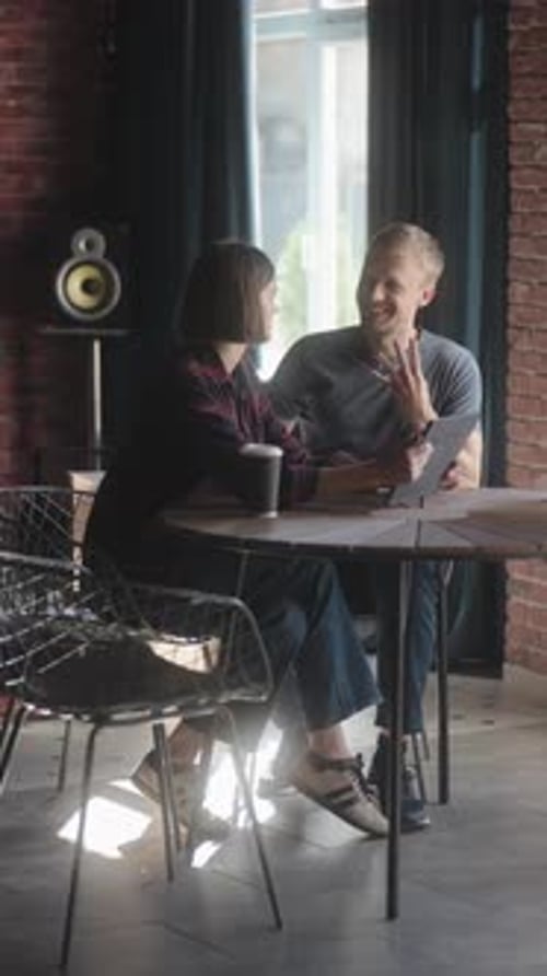 Business Colleagues Discuss a Project Over Coffee in a Modern Office