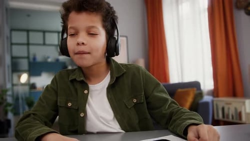 Child Dancing with Headphones in Living Room