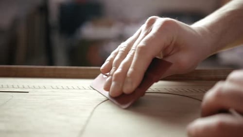 Hands Smoothing Wood with Hand Tool in Workshop