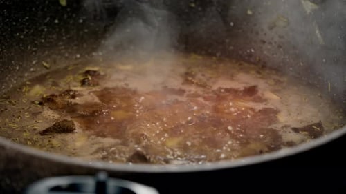 Simmering Beef Stew in Grey Pan Close Up