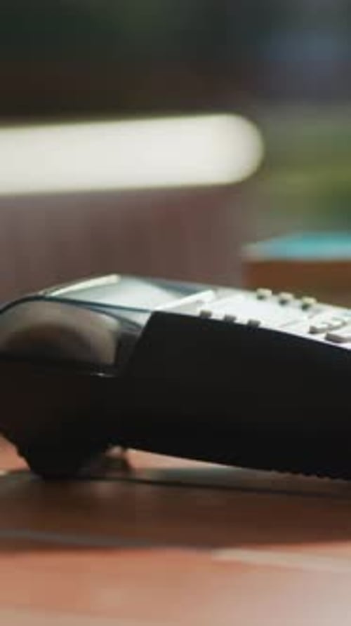 A CloseUp View of a Landline Phone Resting on a Table Surface in an Office Environment