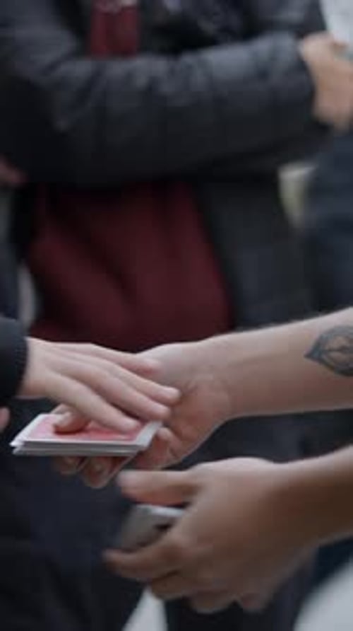 Magician Man Showing Street Magic Trick with Cards