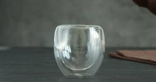 Pouring Tea into a Clear Glass Cup