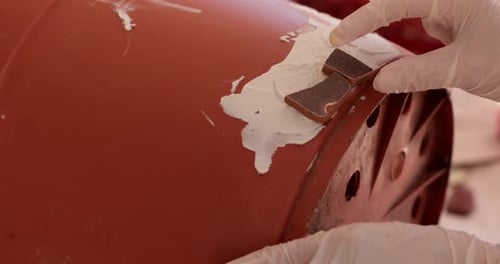 Crafty Hands Affixing Mosaic Tiles to Rounded Surface