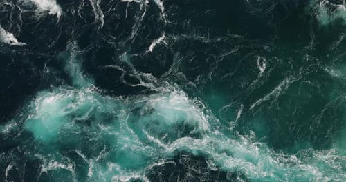 Blue waves of water of the river and the sea meet each other during high tide and low tide.