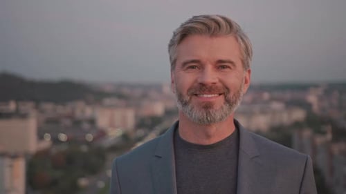 Portrait Young Business Man in Suit Standing Look at Camera Smiling on Roof Top at City Skyscraper