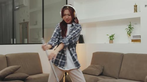 Woman Dances with Mop in Modern Living Room