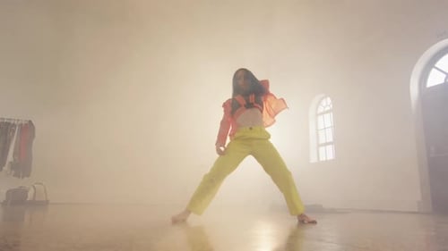 Portrait of caucasian female dancer dancing in dance studio, slow motion