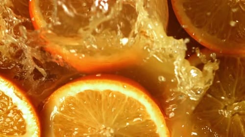 Orange Slices Fall Into the Orange Juice Filmed on a Highspeed Camera at 1000 Fps