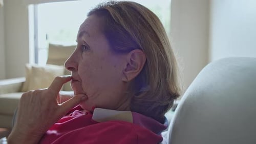 Woman Thinking Deeply While Resting at Home