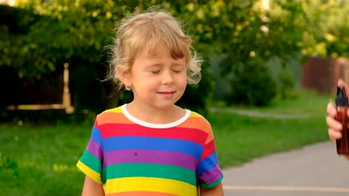 Young Child Sprayed with Mist Outdoors
