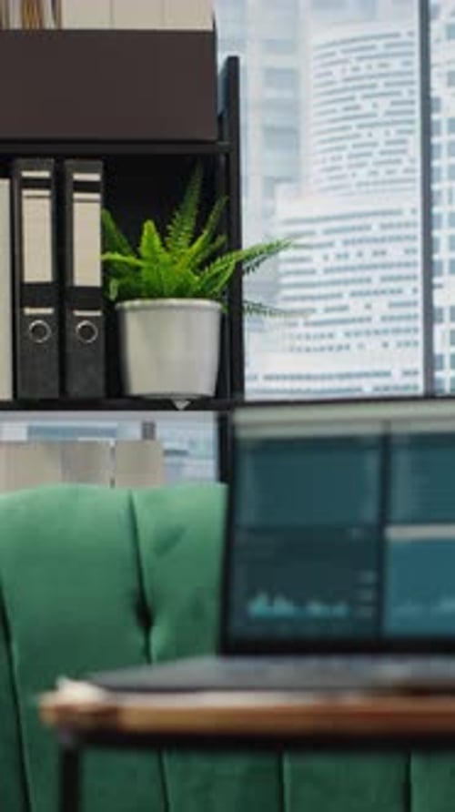 Vertical Video Modern High End Empty Office Space with a Laptop Running Infographics