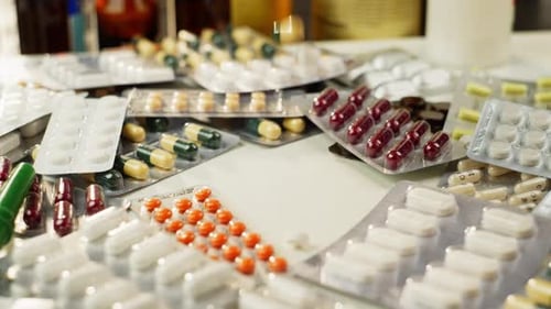 Slow Motion Video of Pills Falling Onto Medicine Boxes and Walls