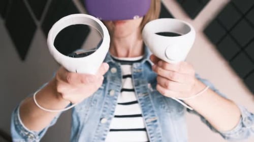 Woman Using Virtual Reality Headset with Controllers