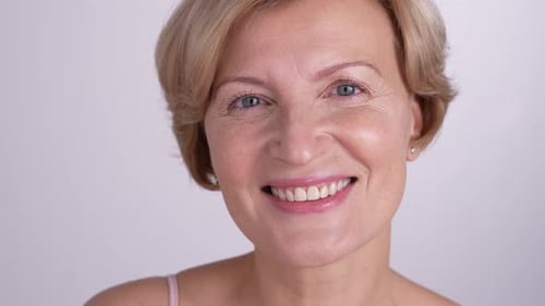Smiling Woman Holding Cotton Pad Close Up