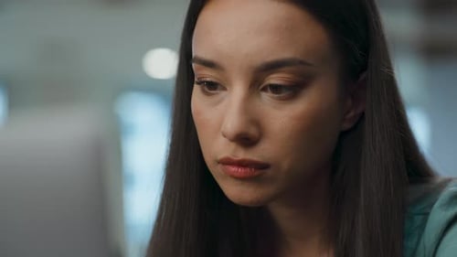 Asian Woman Using Computer in Modern Office Closeup