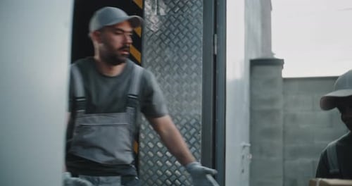 Multiethnic Workers in Uniforms Unloading Cardboard Boxes with Online Orders