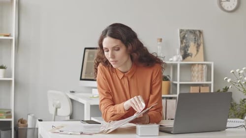 Brunette Businesswoman Analyzing Financial Report