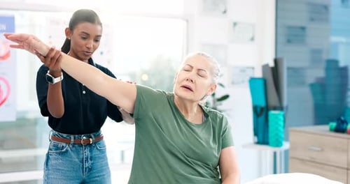 Woman Receiving Arm Therapy from Medical Professional