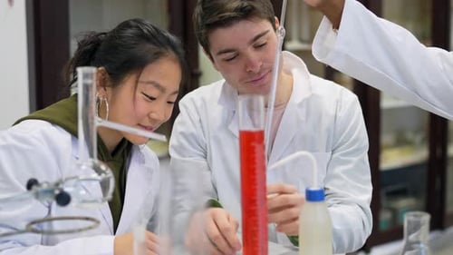 Chemistry Students Performing Titration Experiment in University Laboratory