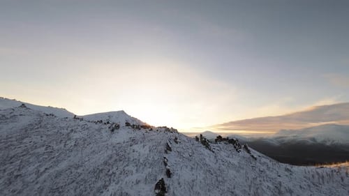 Snowy Mountain Range at Golden Sunrise or Sunset