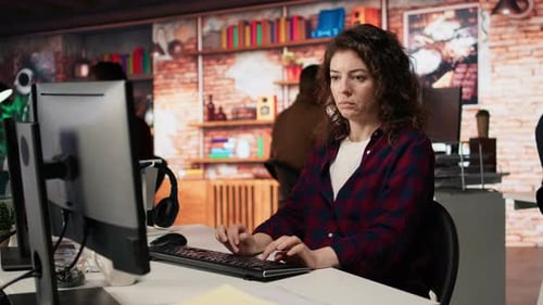 Woman Using PC in Startup Office to Design and Implement Algorithms