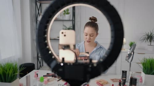 Pretty Caucasian Woman Showing Trendy Makeup on Her Own Face Filming Tutorial Beauty Blogger