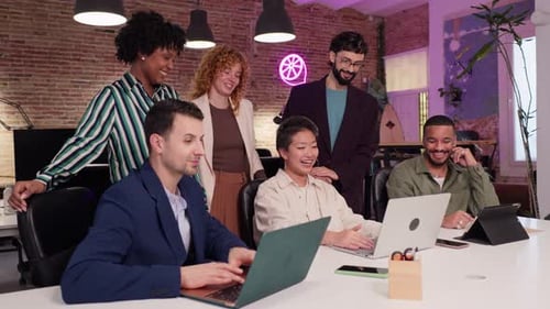 Coworkers Collaborating on Project in Modern Office in Slow Motion