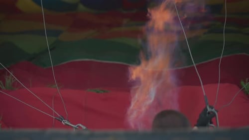 Head View Person Igniting Hot Air Balloon Burner Flame During Preflight Launch in Field