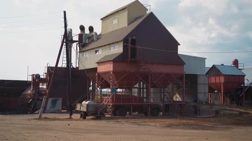 Loading Grains Into Truck From Funnel Near Granary Building