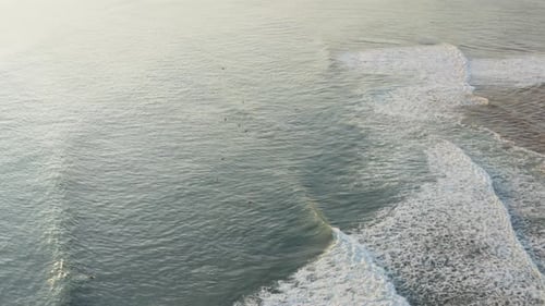 Aerial View of Ocean Waves at Sunset